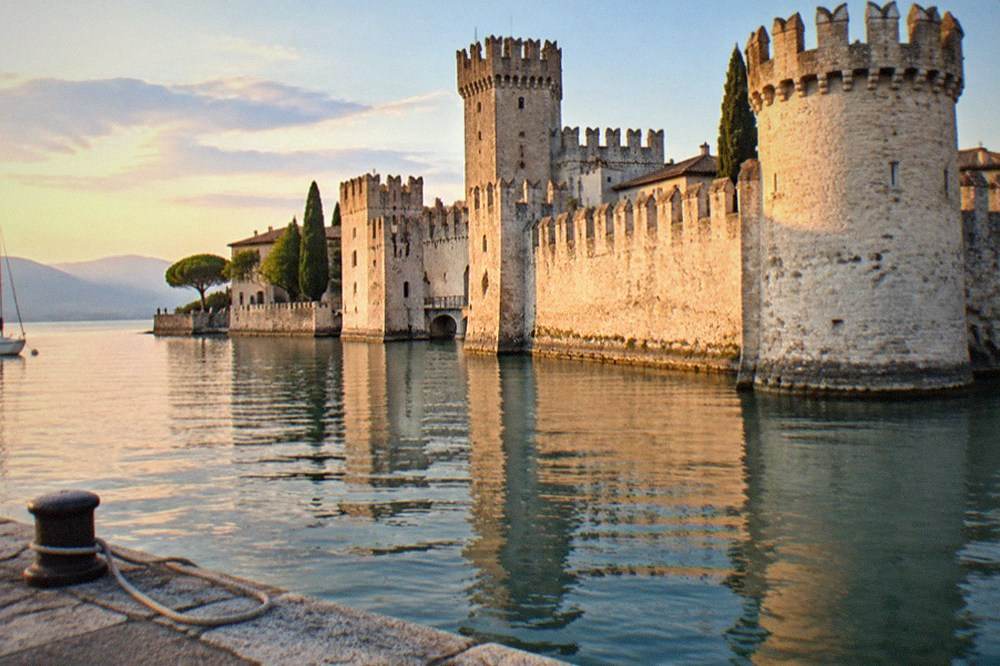 Sirmione old town and Scaliger castle beside the water in late evening light