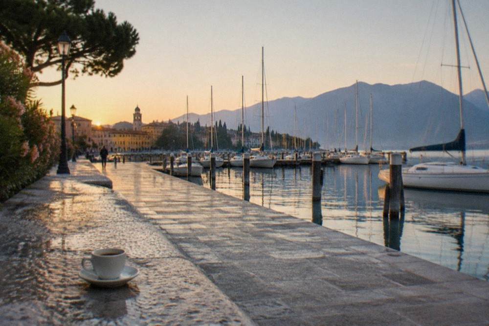 Desenzano lakefront promenade with the harbour and moored boats in morning light