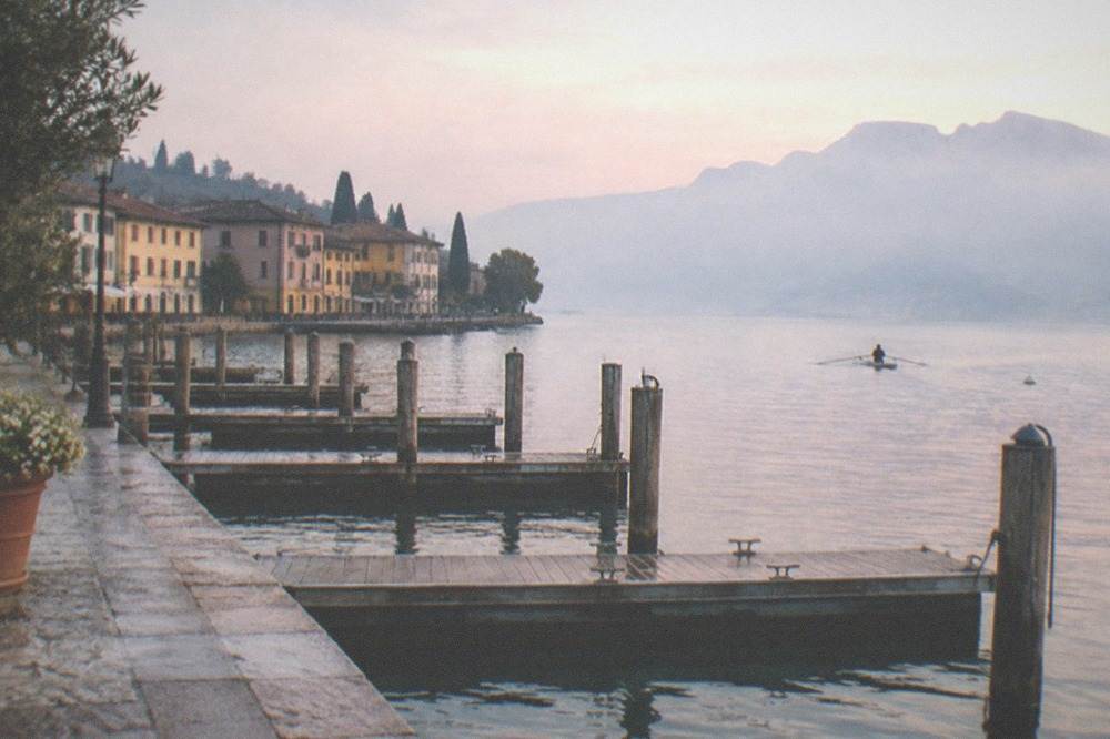 A lakeside promenade with closed mooring pontoons in early morning light