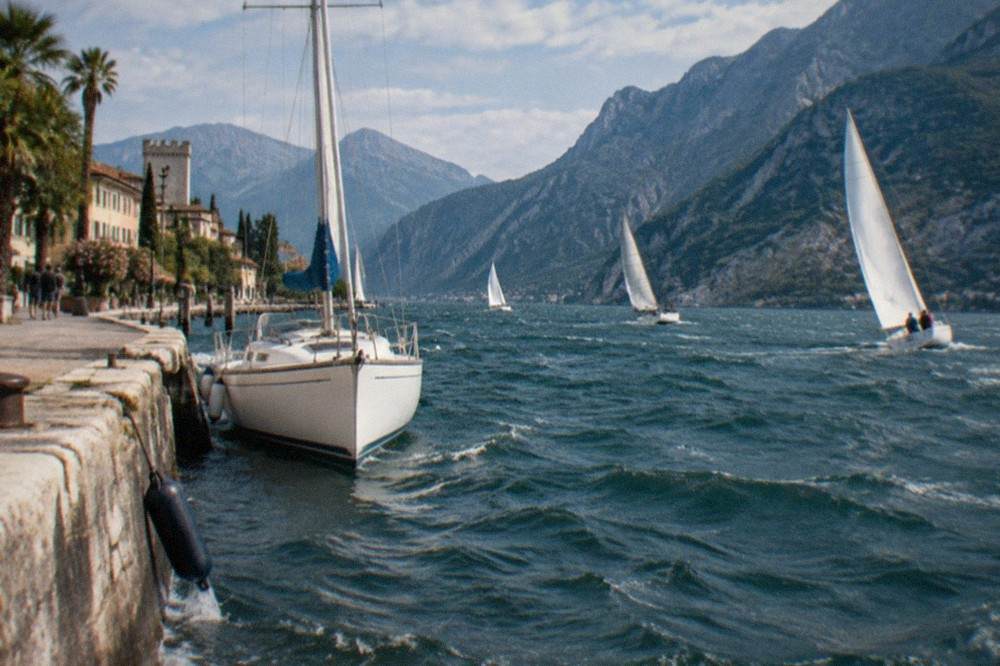 Sailboats heeling in afternoon wind on the northern part of Lake Garda