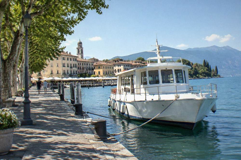 The ferry landing at Desenzano with a passenger boat moored at the pier